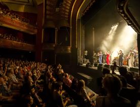 A musical performance at The Opera House with an applauding audience.