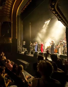 A musical performance at The Opera House with an applauding audience.