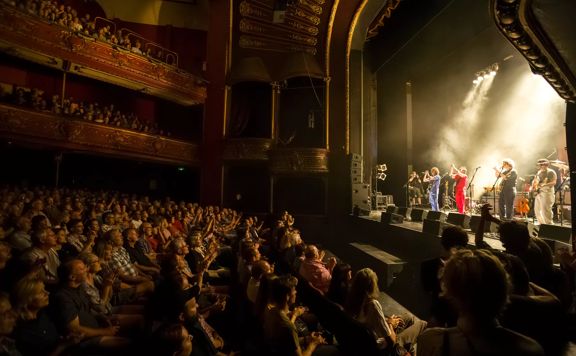 A musical performance at The Opera House with an applauding audience.