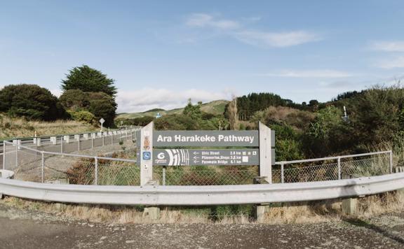 Ara Harakeke Pathway sign showing estimated times to various points along the trail.