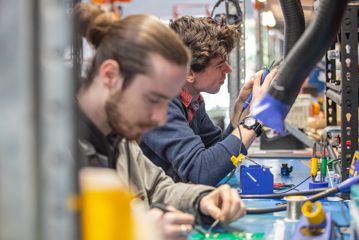 Two OpenStar employees work in the company's warehouse.
