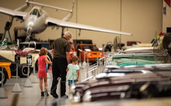 A man and two children are walking through the Southward Car Museum in Paraparaumu in the Kāpiti Coast.