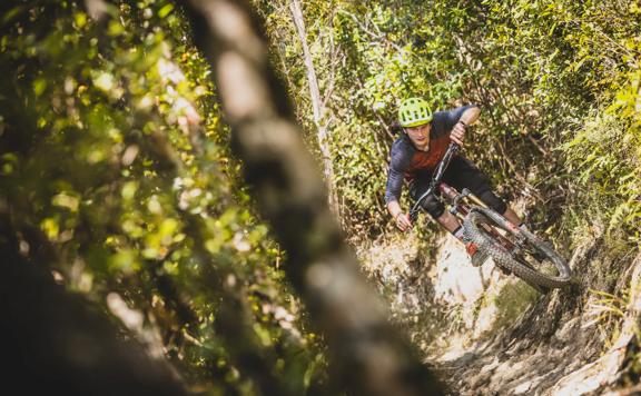 Mountain biker going around a sharp corner on the 491 track in Waiu Park