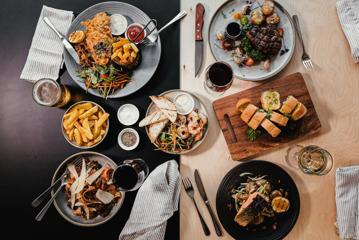 Plates of food served on a table at Atura hotel.