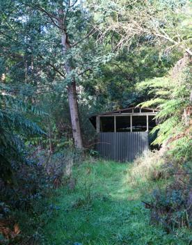 Mangaroa Valley Road screen location, a scenic rural setting with native forest, farmland, and a mountainous backdrop.