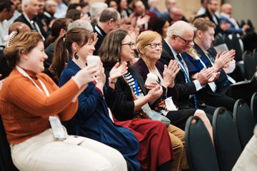 People clap while in the audience at the WaterNZ conference.