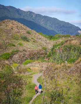 Two people walking in Queen Elizabeth Regional Park.