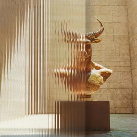 A minotaur bust behind fluted glass.