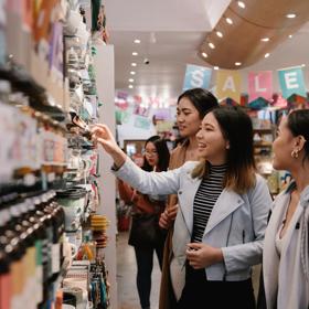 Three people shopping at Iko Iko, a small, quirky gift shop located on Cuba Street in Te Aro Wellington.