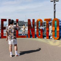 Family taking a photo with the Wellington sign.