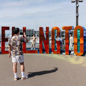 Family taking a photo with the Wellington sign.