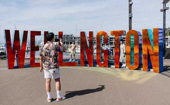 Family taking a photo with the Wellington sign.