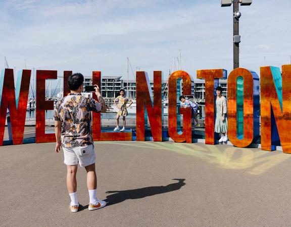 Family taking a photo with the Wellington sign.