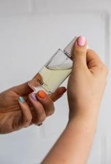 Hands with colourful fingernails holding perfume bottle from Abel Odour perfumery in Wellington.