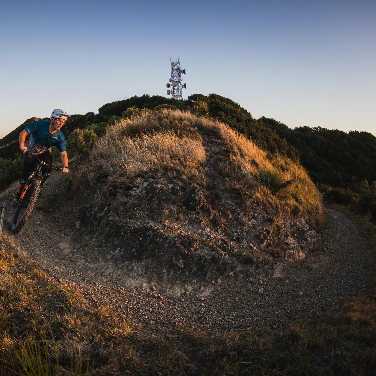 A cyclist rides along the trails at Mākara Peak Mountain Bike Park.