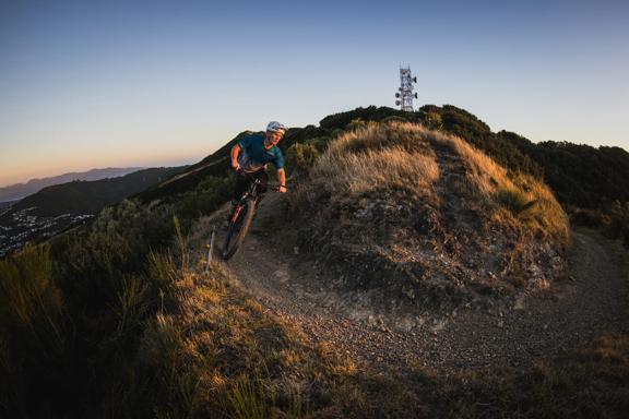 A cyclist rides along the trails at Mākara Peak Mountain Bike Park.