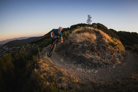 A cyclist rides along the trails at Mākara Peak Mountain Bike Park.