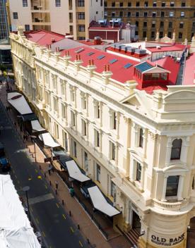 The mix of modern and old buildings along Lambton Quay, including the old supreme court, and old bank.