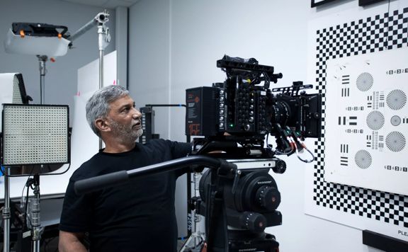 A person standing next to a large camera at Portsmouth Film Equipment Rental located in Kilbirnie, Wellington.