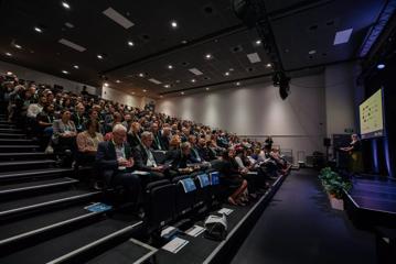 A full audience listening to a presentation at the Life Sciences Summit at Shed 6.