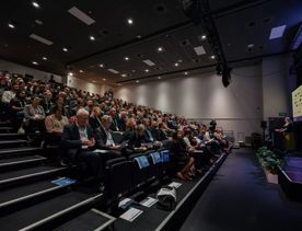 A full audience listening to a presentation at the Life Sciences Summit at Shed 6.