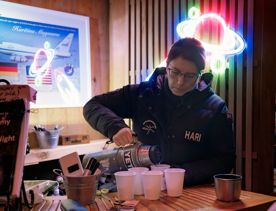 Haritina Mogosanu (Hari), co-founder of Star Safari, pours tea from a thermos for guests.