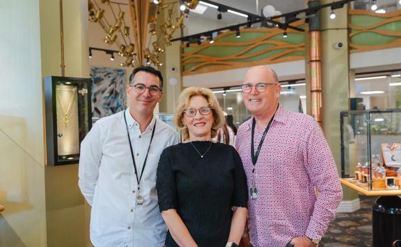 A group portrait of Chris Benham, Christine Douglas, and Ian Douglas, co-directors of The Village Goldsmith.