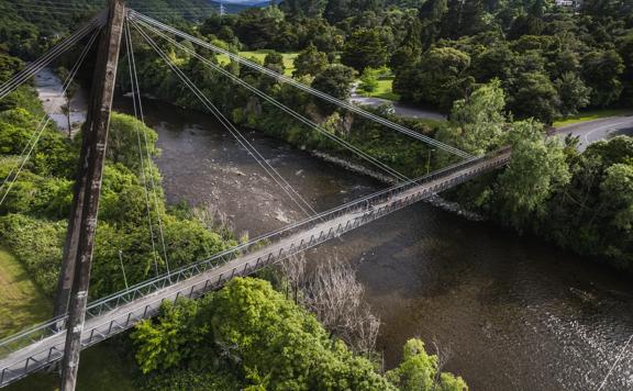 An aerial shot of cyclists crossing a bridge over the Hutt River.