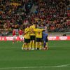 Wellington Phoenix team members in a huddle during a match vs Wrexham.