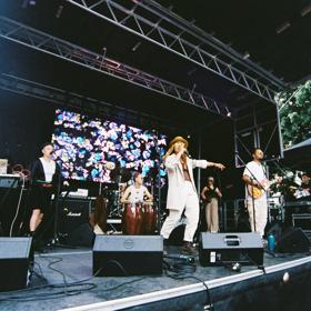 MĀ & The Fly Hunnies, an artist-run collective based in Te Whanganui-a-Tara, performing on stage at the Newtown Festival in 2023.
