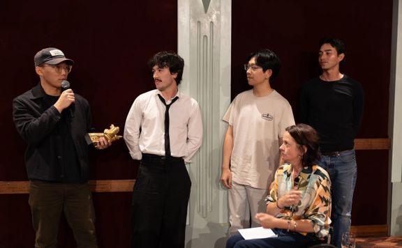 Kang Andrew Tian and his team accept the Supreme Award at the Wellington Animation Film Festival.