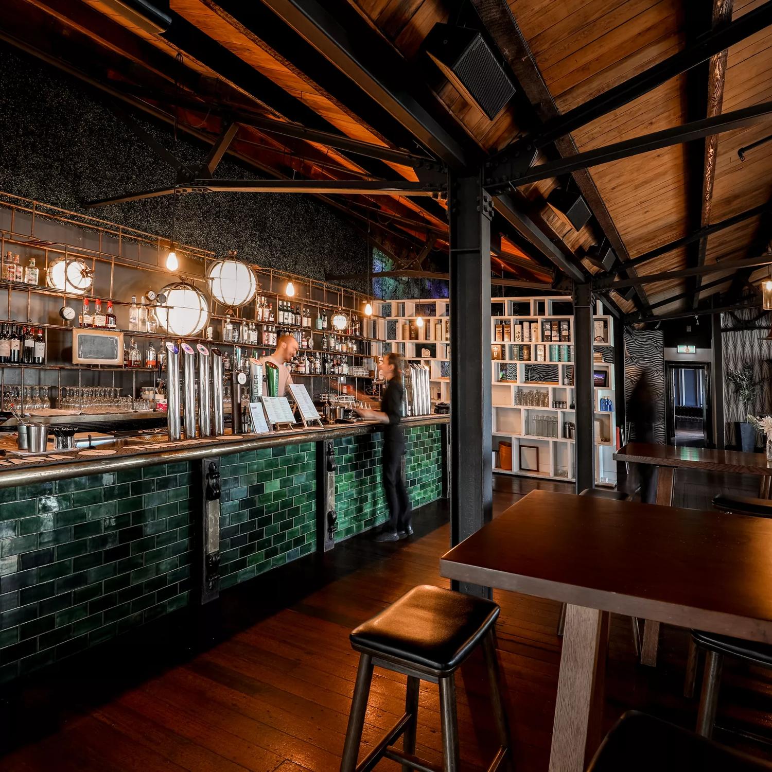 Two workers on either side of the bench inside Foxglove Bar & Kitchen.