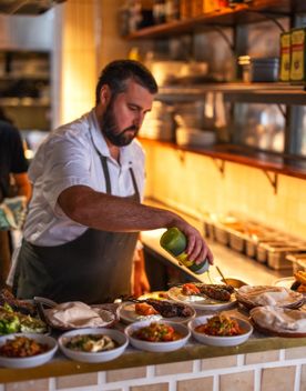 Chef at Kisa garnishing Middle Eastern inspired-cuisine before it is served.