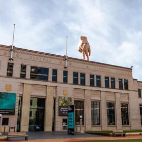 The exterior of the City Gallery with 5-metre tall hand statue ‘Quasi’ standing atop.