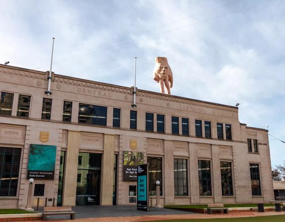 The exterior of the City Gallery with 5-metre tall hand statue ‘Quasi’ standing atop.