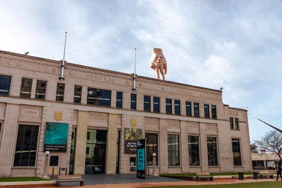 The exterior of the City Gallery with 5-metre tall hand statue ‘Quasi’ standing atop.