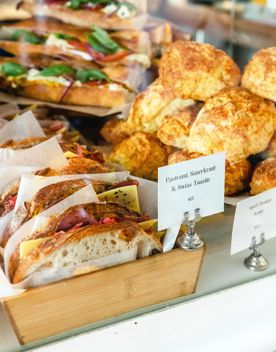 Cabinet food at Tomboy cafe: aged cheddar scone, and a pastrami, sauerkraut and swiss cheese toastie.