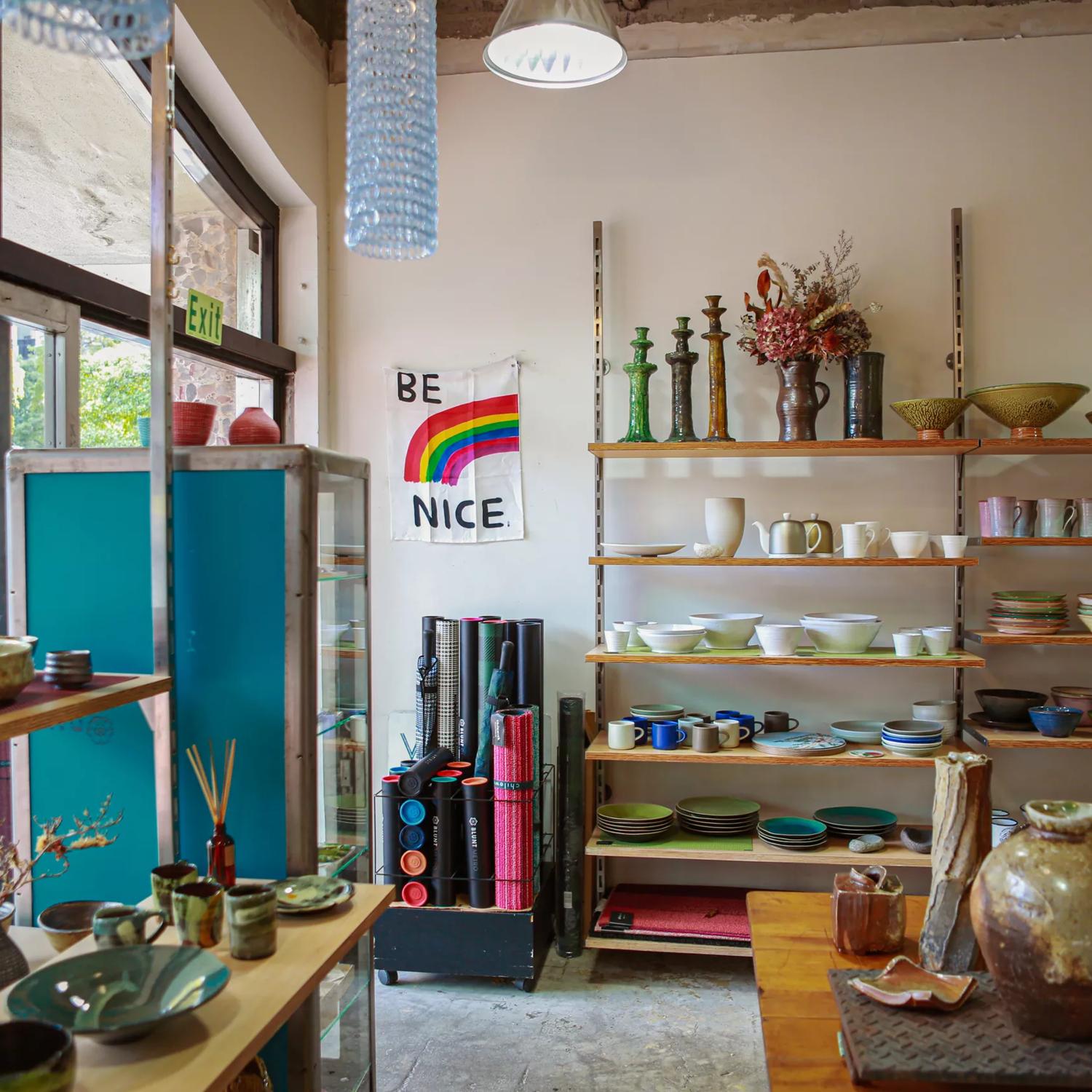 Inside Vessel gift shop, we can see a large variety of dinnerware on the shelves.