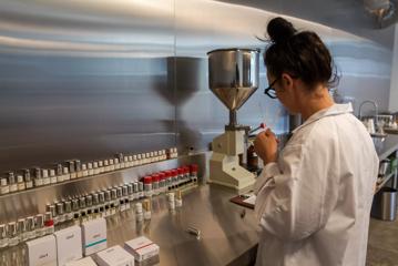 A perfumer standing at workstation, sampling scents at Abel Odor Perfumery in Wellington.