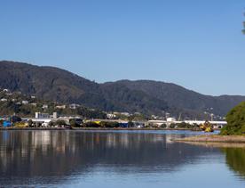 The Petone boat ramp, Hikoikoi,  with colourful boat sheds and boats in the morning sun.