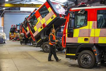 A fraser Engineering worker checking over their work on fire trucks.