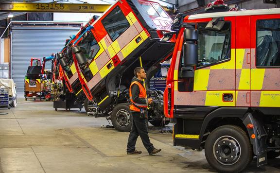 A fraser Engineering worker checking over their work on fire trucks.