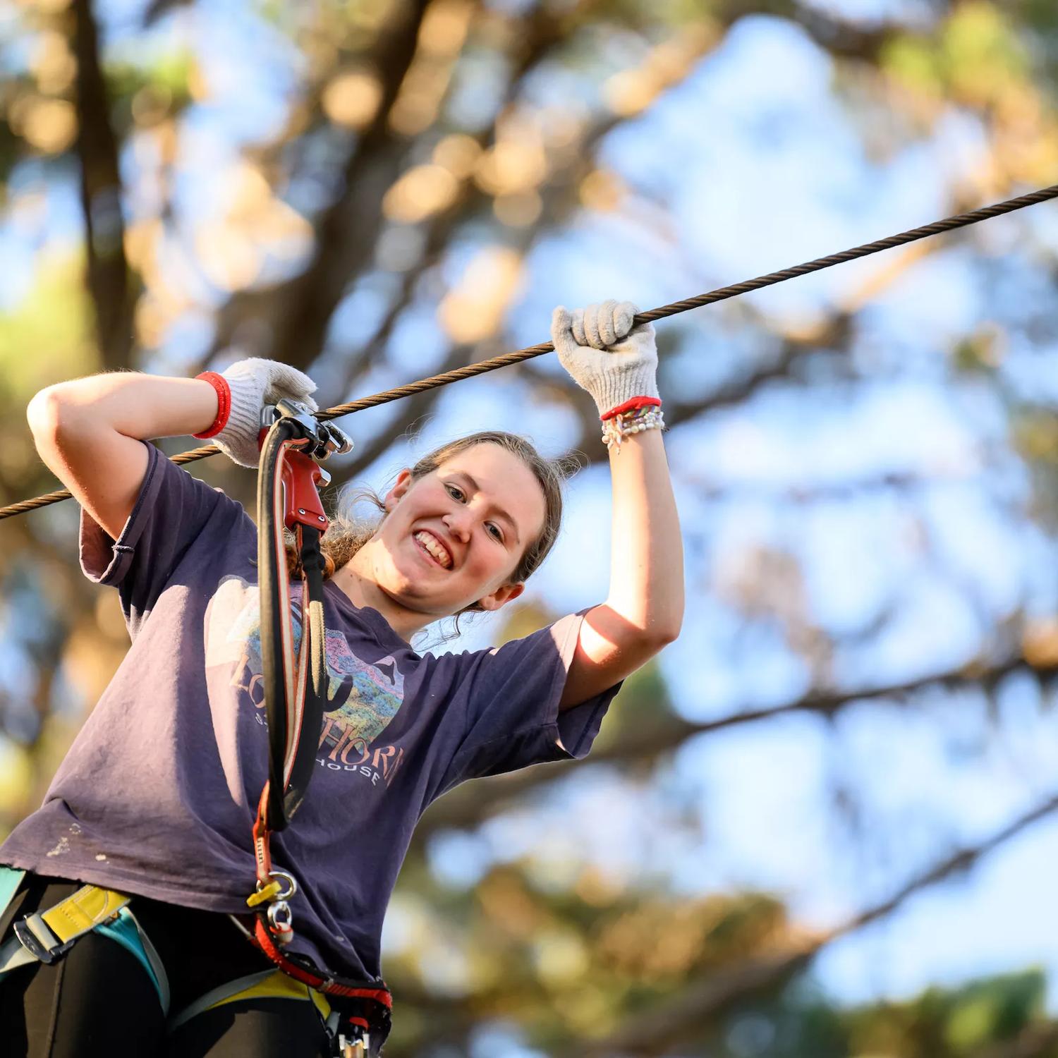 A child on a zipline amongst the trees at Adrenalin Forest.