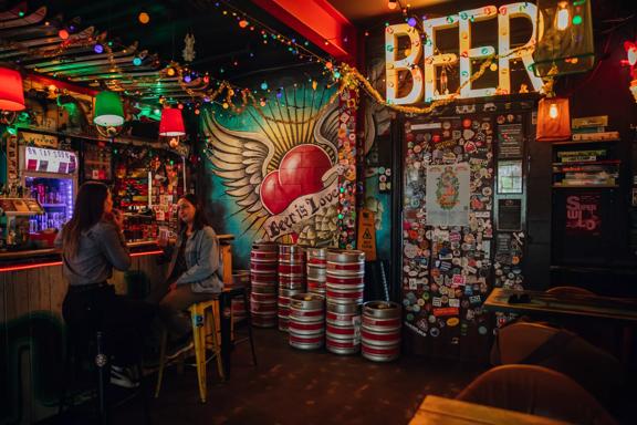 Two people enjoying drinks at Golding's Free Dive, a cool, kitsch, and cosy laneway bar in Te Aro, Wellington.