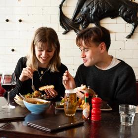 Two people enjoy food and drinks at El Matador.