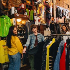 Three friends are shopping at Hunters & Collectors.
