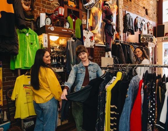 Three friends are shopping at Hunters & Collectors.