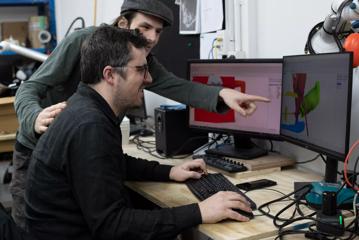 Two people working on a computer to create special effects for films.