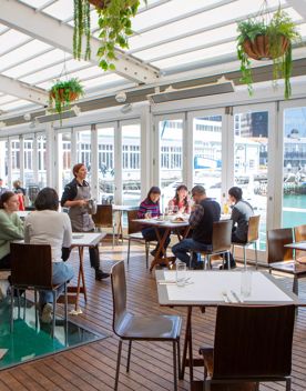 People dining at Dockside Restaurant & Bar on a sunny day.