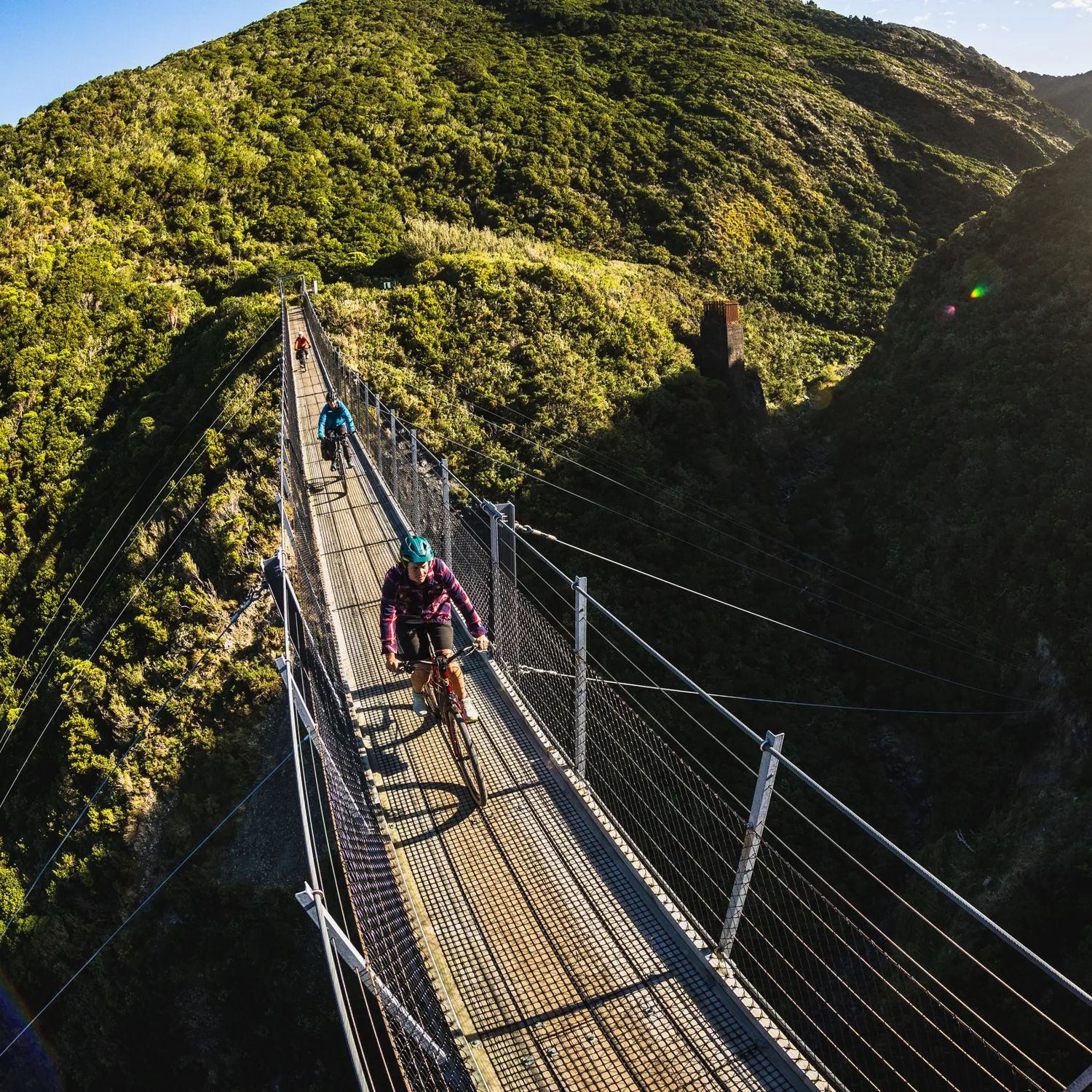 2 bikers going over the Siberia Gully bridge, on the Rail Trail Section on the Remutaka Cycle Trail.